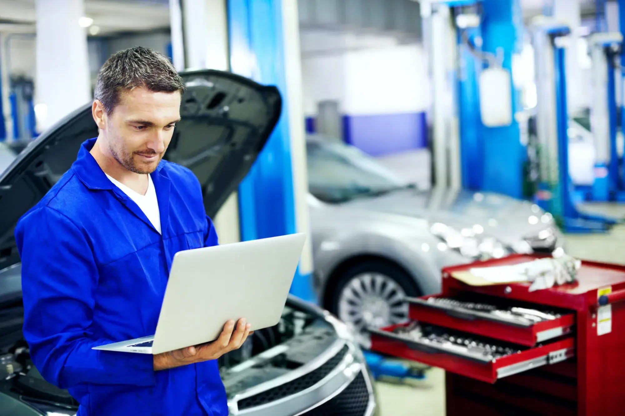 man-laptop-car-mechanic-workshop-with-research-review-cost-quote-maintenance-service-technician-person-browsing-garage-with-computer-fix-vehicle-report-repair-expenses